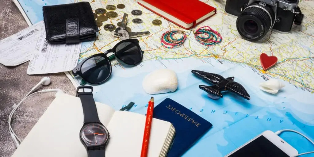 International traveling accessories, map, camera, passport, phone, wallet, and sunglasses