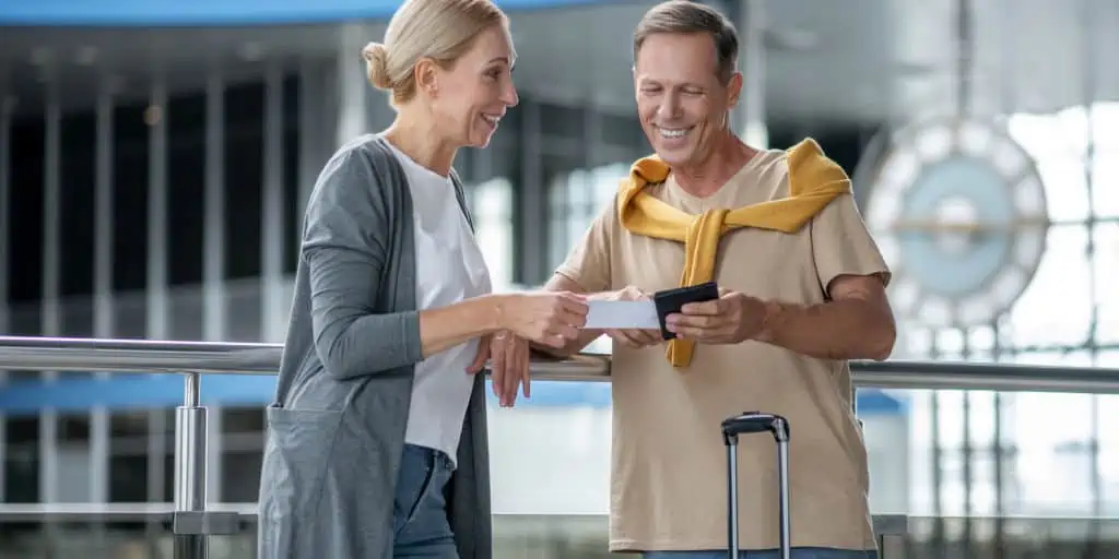 male and female couple in airport waiting to travel