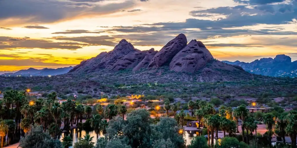 arizona city in foreground with mountains in background at sunset